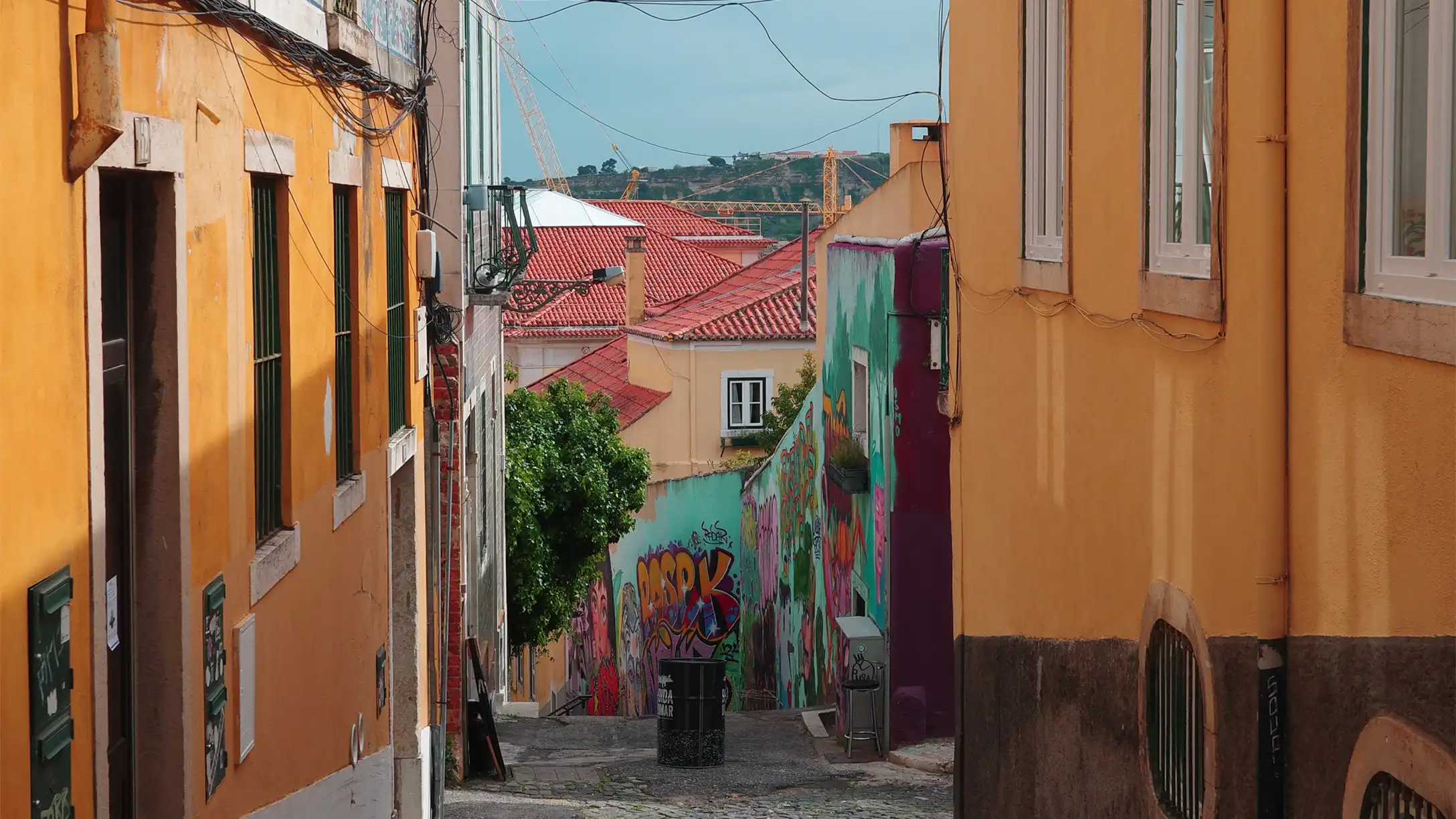 Steep cobbled side street in Porto lined with colourful facades